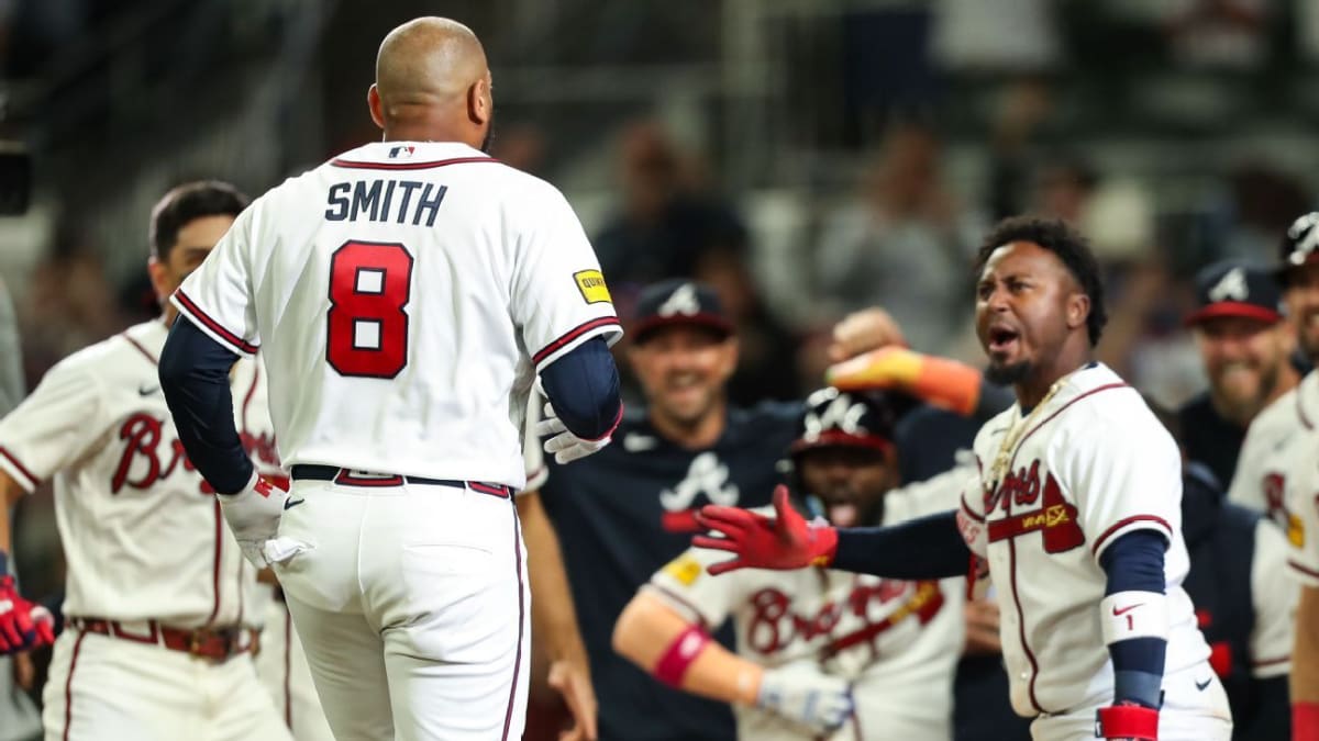 Dominic Smith celebrates at home plate after hitting walk-off grand slam for Atlanta Braves
