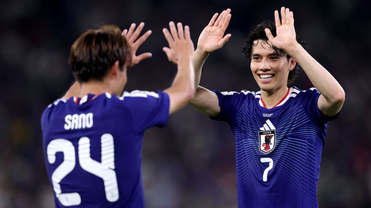 Japanese soccer players celebrating during their historic 4-0 victory over Tunisia at World Cup