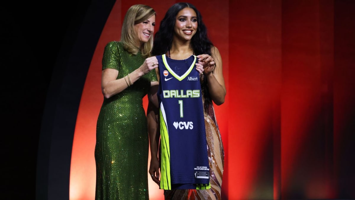 Azzi Fudd smiling in WNBA draft cap after being selected first overall by Dallas Wings