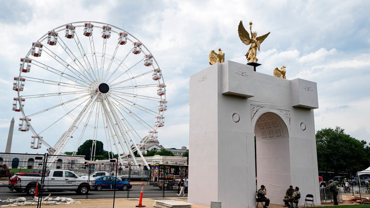 Large Freedom 250 Ferris wheel stands on National Mall with American flags during anniversary celebration