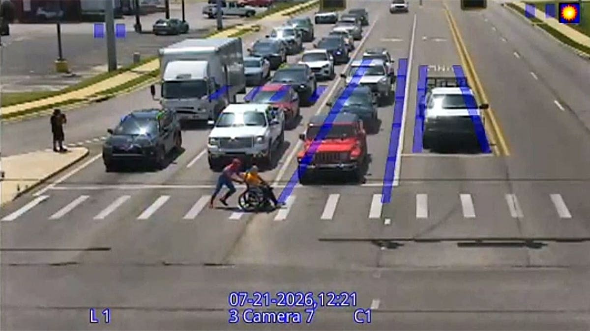 Man in Spider-Man Costume Helps Wheelchair User Cross Street - Image 2