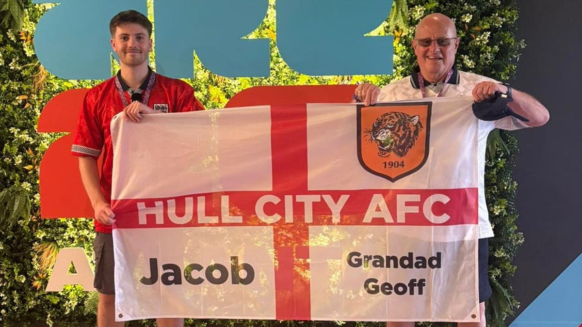 Young man Jacob Allmendinger smiling with his 80-year-old grandfather Geoff at FIFA World Cup