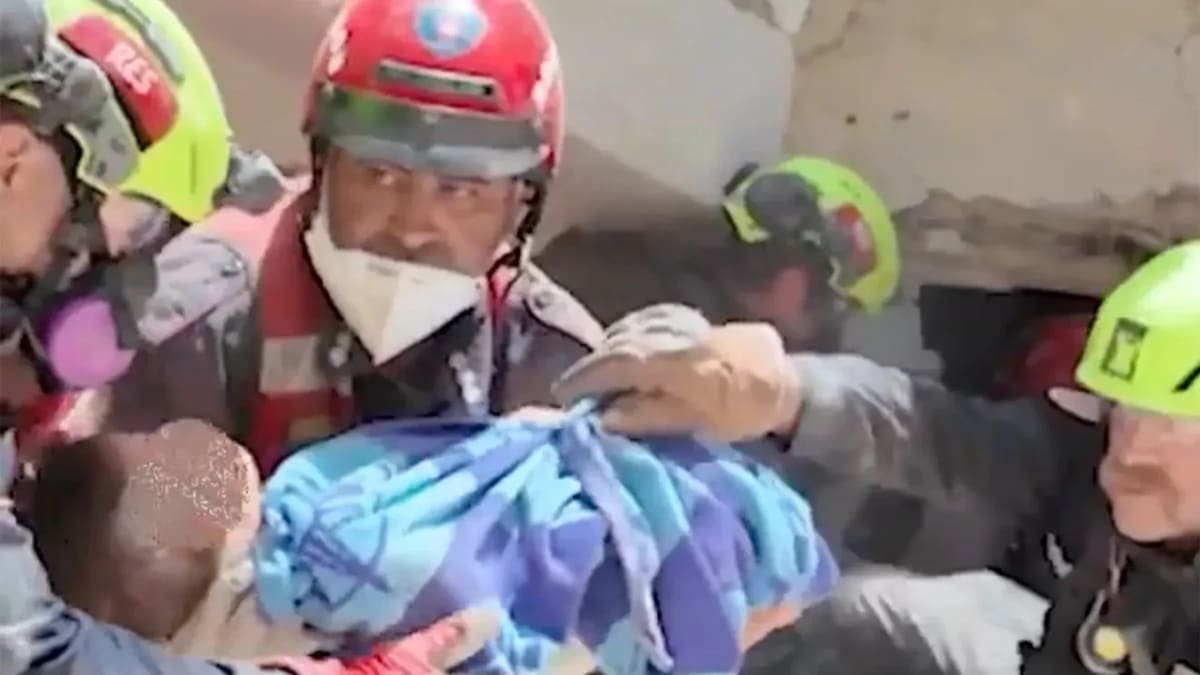 US rescue workers carefully extracting survivors from collapsed building rubble in Venezuela