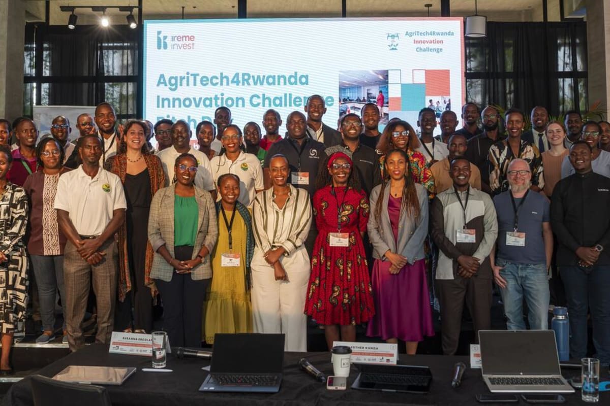 Young African entrepreneurs working on agricultural technology solutions using laptops and meeting with farmers in Rwanda