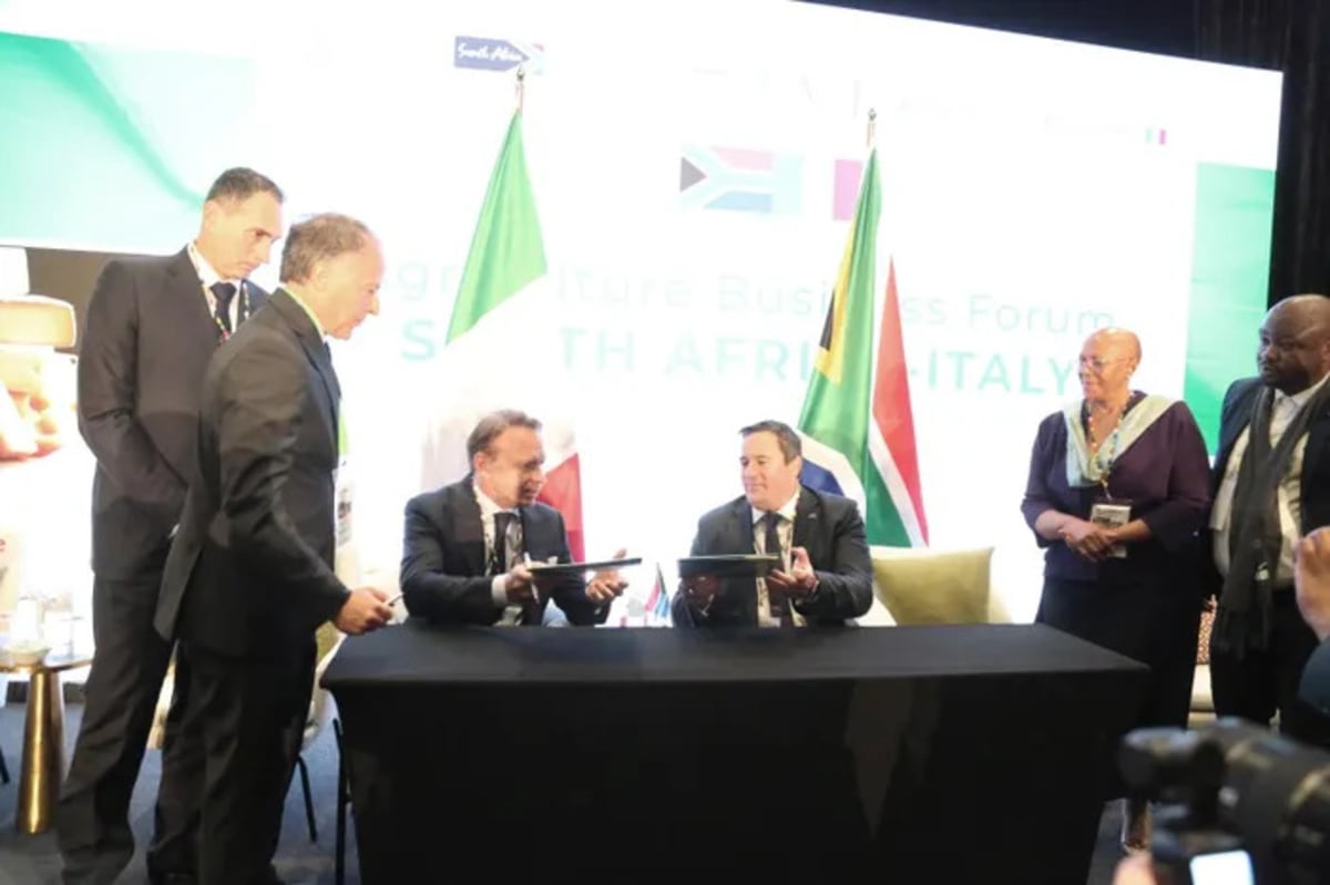 South African and Italian officials shaking hands at agricultural partnership signing ceremony