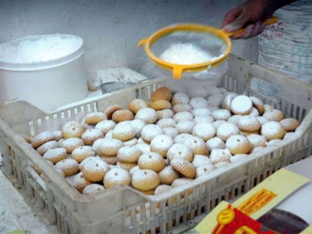 Egyptian families receiving traditional Eid cookies at community food distribution center