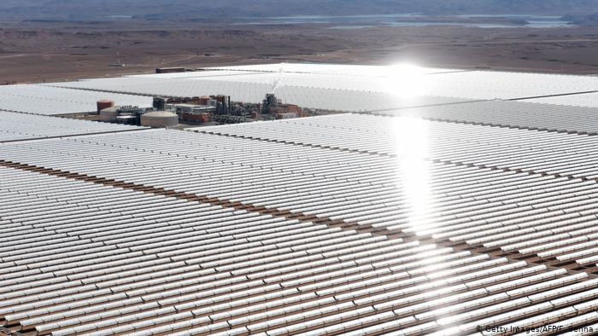 Solar panels installed on rooftop of Egyptian factory under bright blue sky