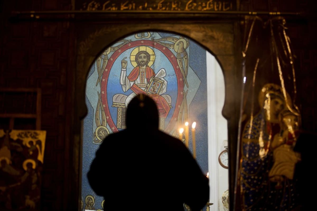 Church steeples and mosque minarets standing together in an Egyptian cityscape under clear skies