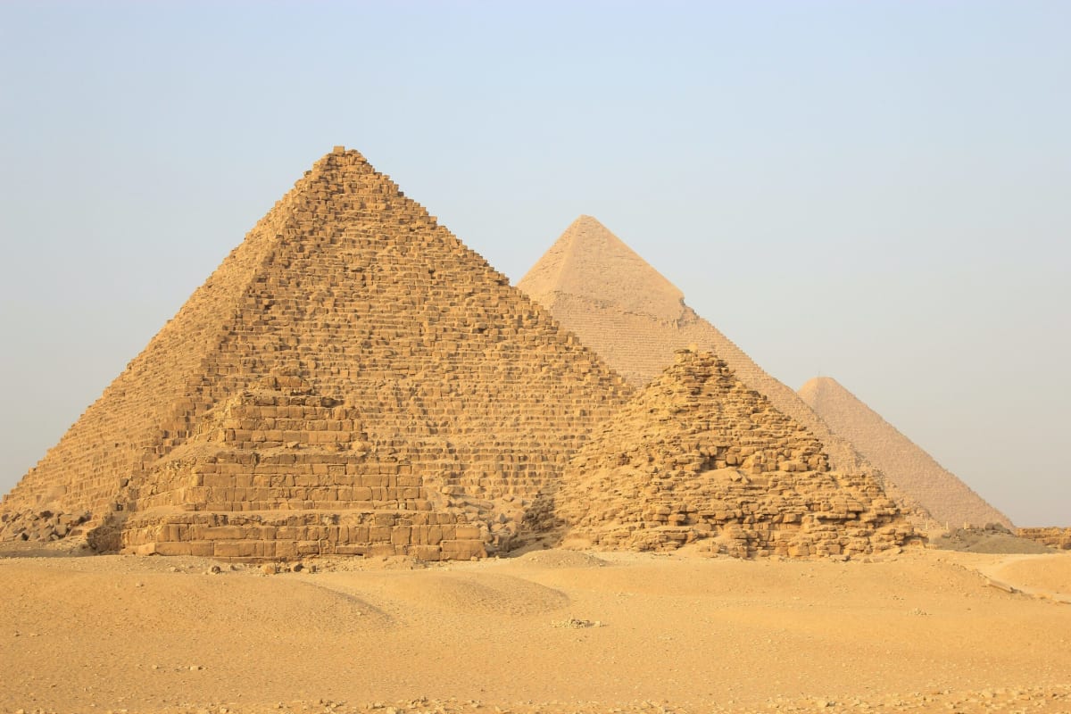 Egypt's Great Pyramids of Giza with modern visitors exploring the ancient monuments