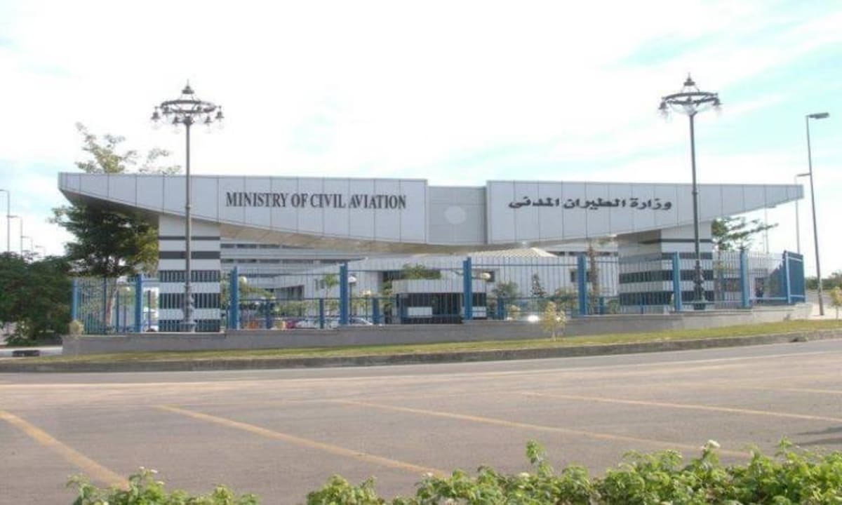 Modern Egyptian airport terminal with digital screens displaying flight information and passengers