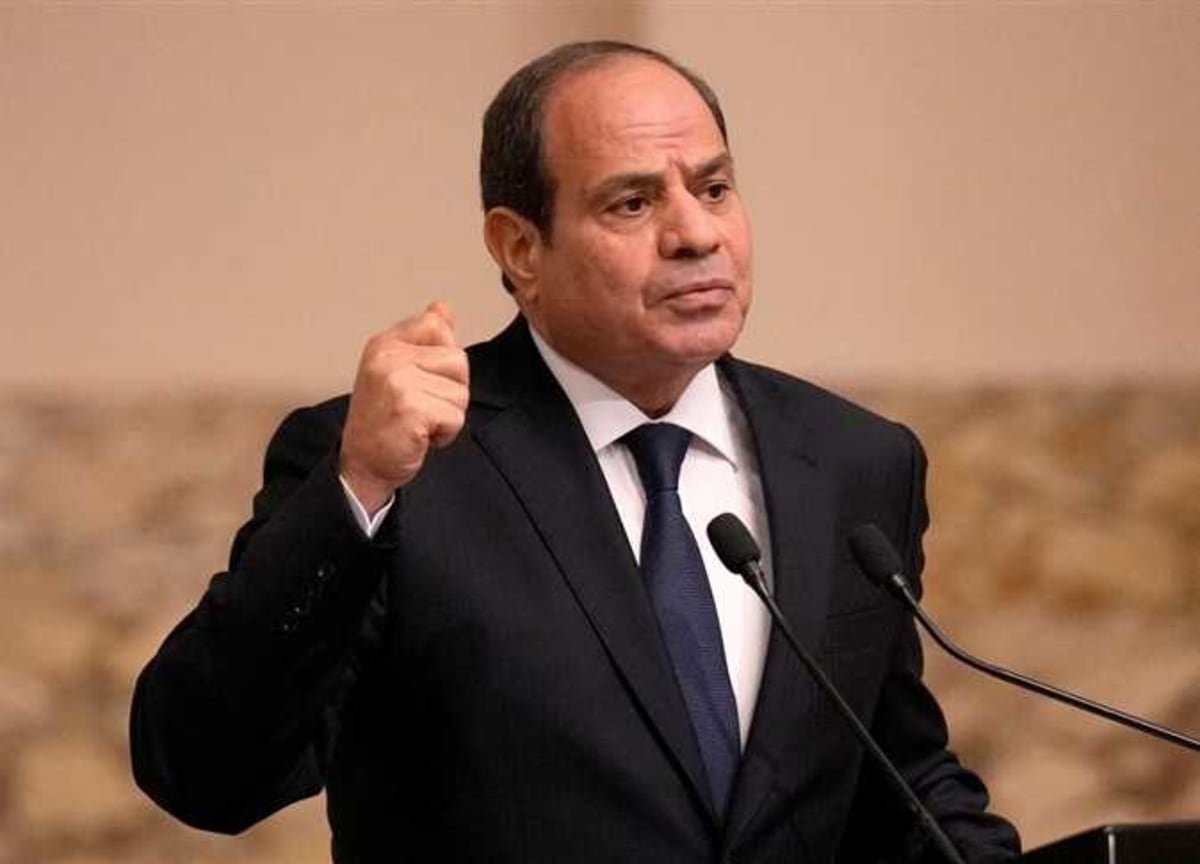 Egyptian flag waving against blue sky representing national anniversary and presidential pardon announcement