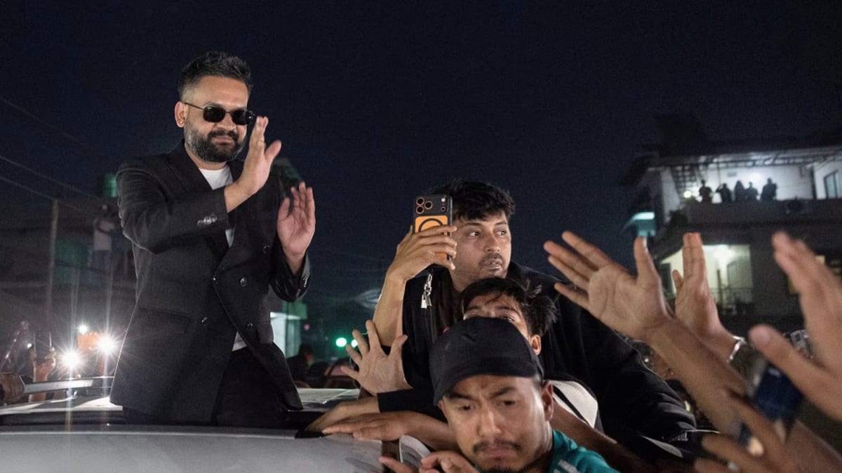 Balendra Shah in sunglasses greeting celebrating supporters after historic Nepal election victory