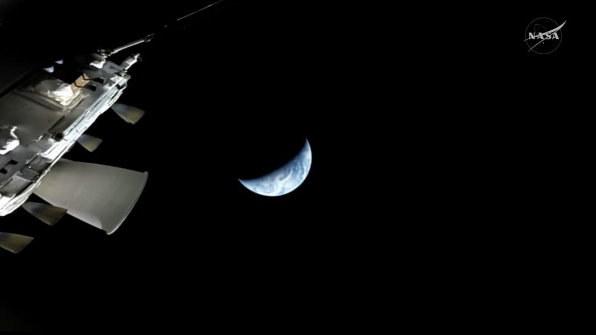 Four Artemis II astronauts embrace on stage at Houston's Johnson Space Center homecoming