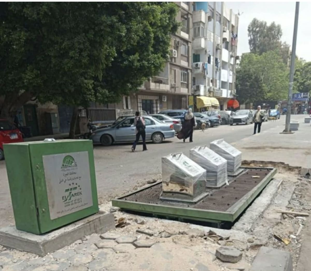 Underground waste container being installed in urban Egyptian street in Giza