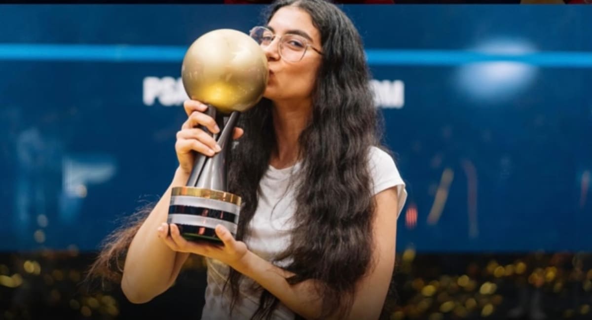 Egyptian squash player Amina Orfi celebrating her historic World Championship victory on court