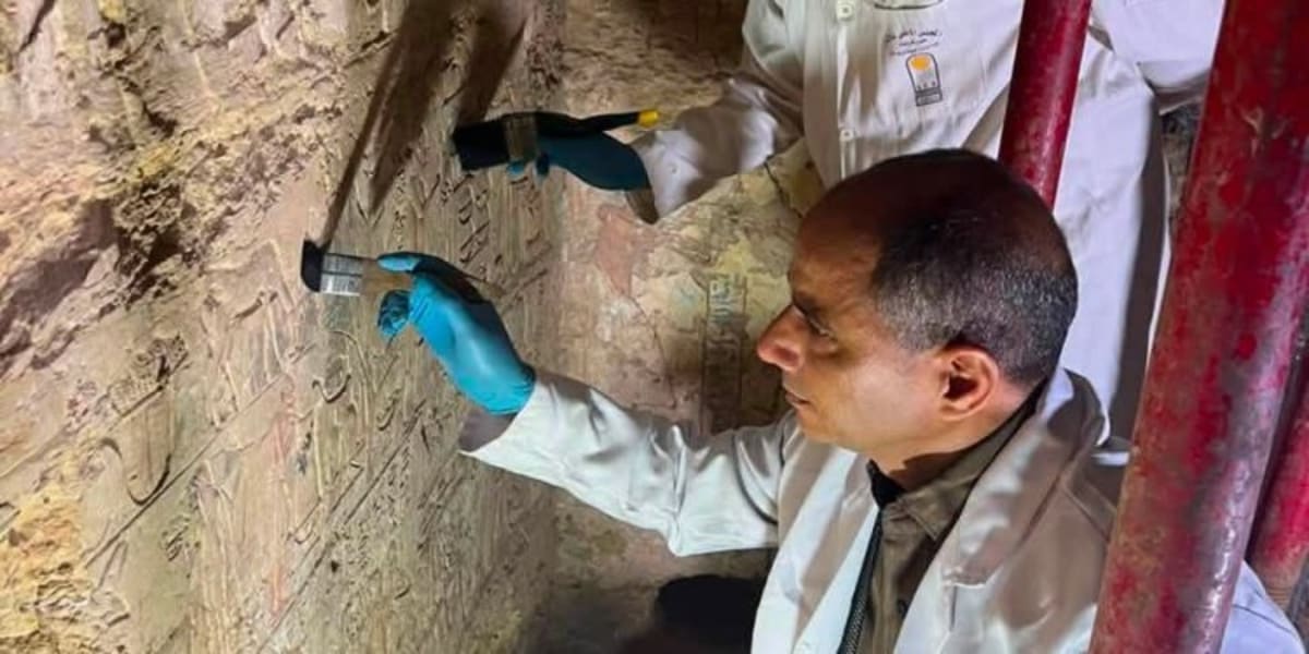 Ancient Egyptian tomb entrance carved into rock at Saqqara archaeological site in Egypt