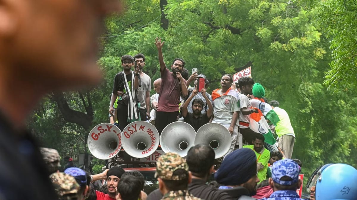 Young protesters celebrating with Indian flags at Jantar Mantar in New Delhi, India