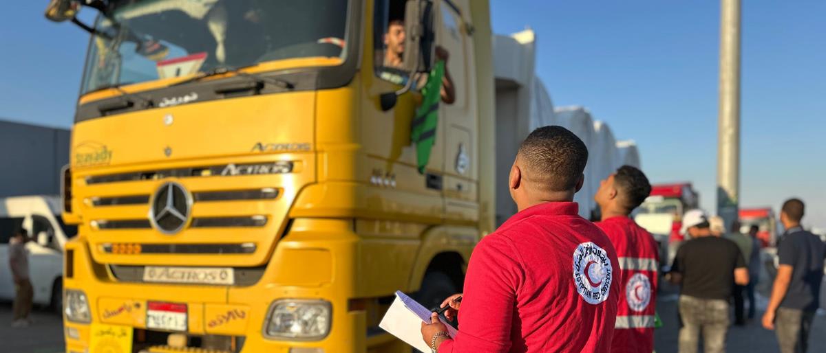 Humanitarian aid trucks lined up at border crossing carrying food and supplies