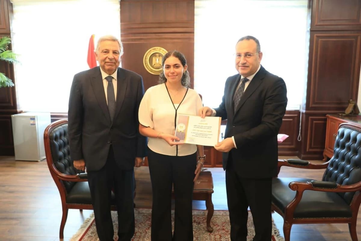 Young female medical student receiving official recognition for helping fire victims in Cairo