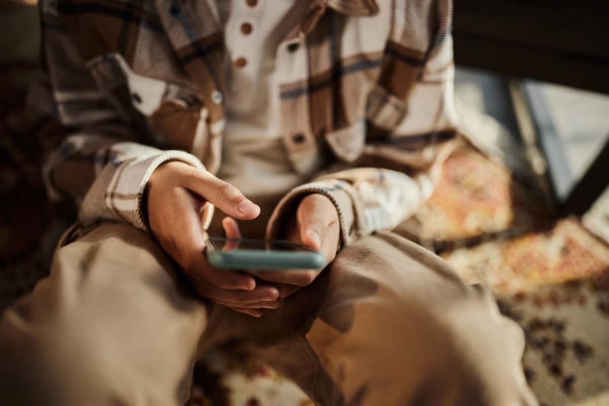 Smartphone displaying Instagram and Facebook apps with parental controls and time limit notifications visible on screen