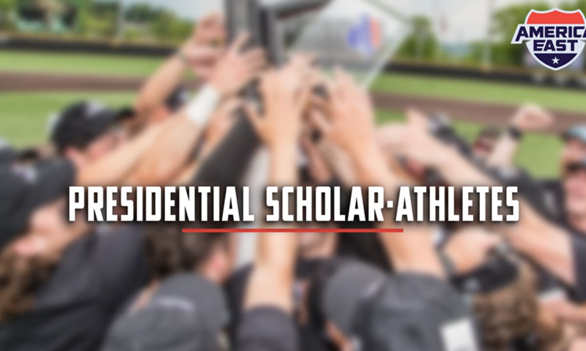 College student-athletes in caps and gowns celebrating graduation with diplomas raised high