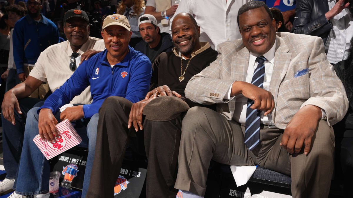 Former New York Knicks players Patrick Ewing, Larry Johnson, and John Starks cheering courtside at Madison Square Garden