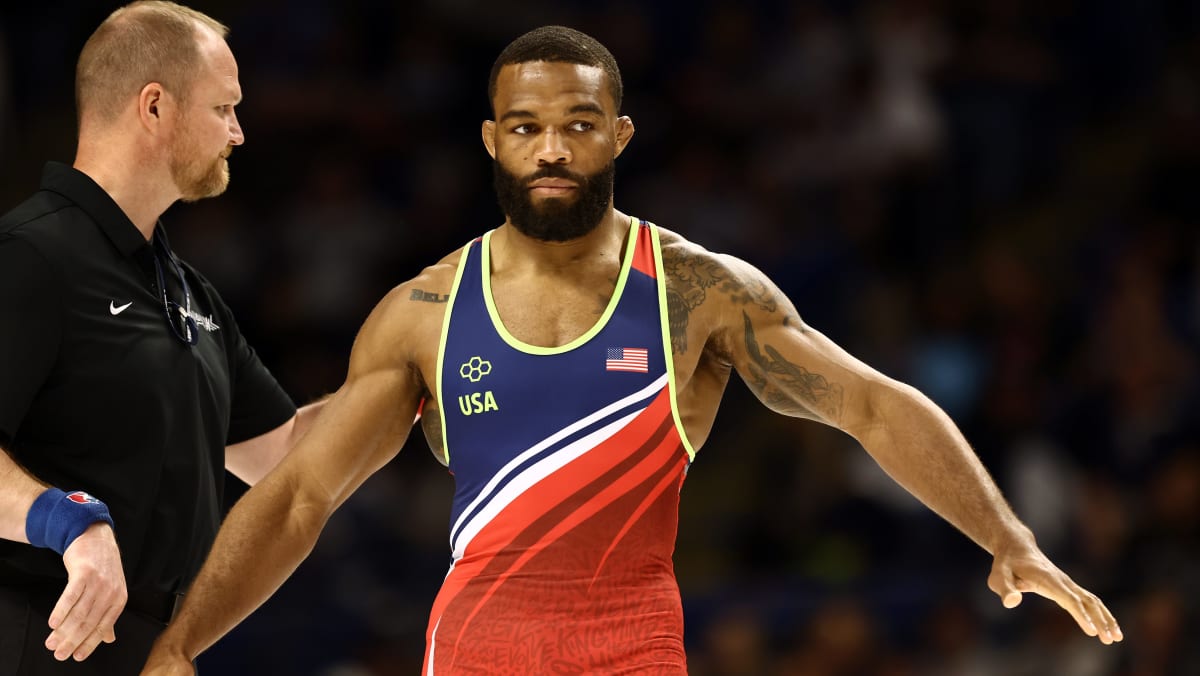Olympic gold medalist Jordan Burroughs in wrestling stance on competition mat during match
