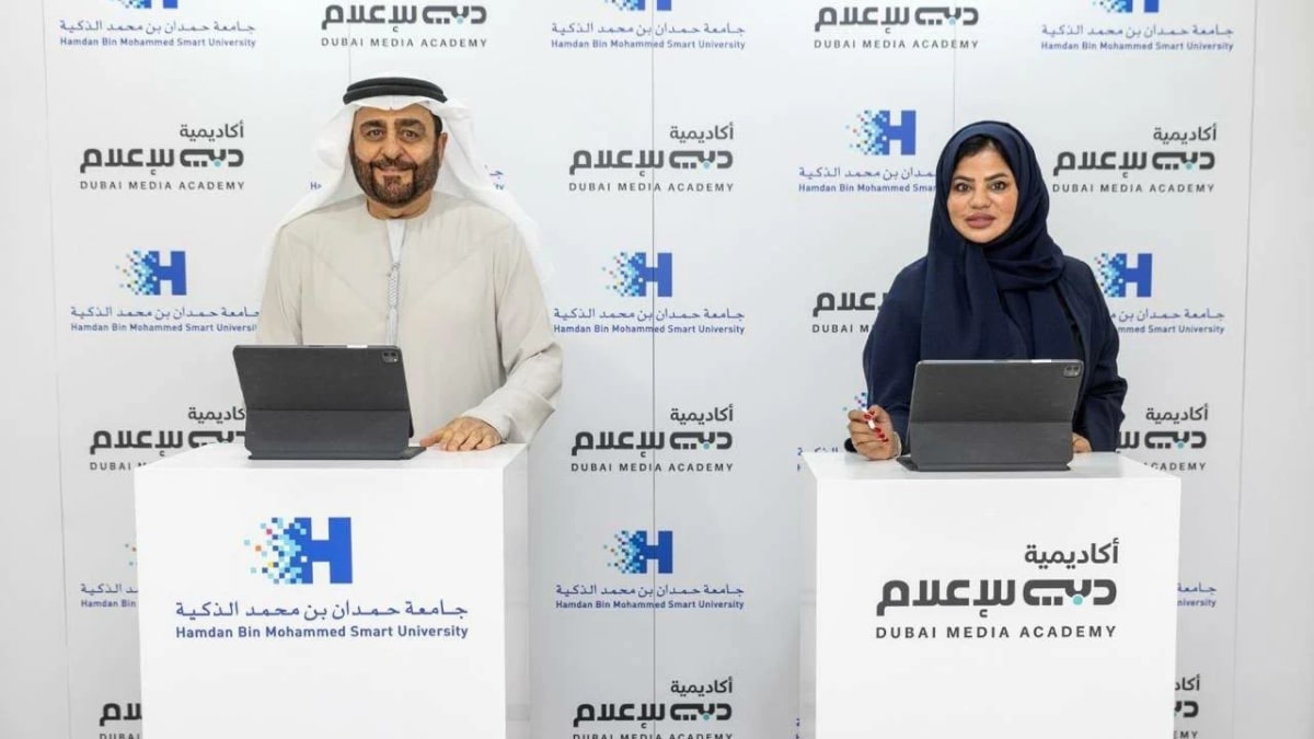 University officials shake hands at signing ceremony for Dubai media education partnership agreement