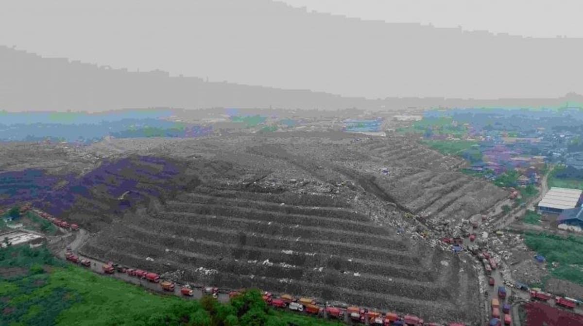 Indonesian landfill site with gas collection pipes converting methane into clean cooking fuel for local communities