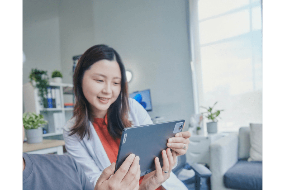 ** Small business owner working on laptop with mentor reviewing business plans together