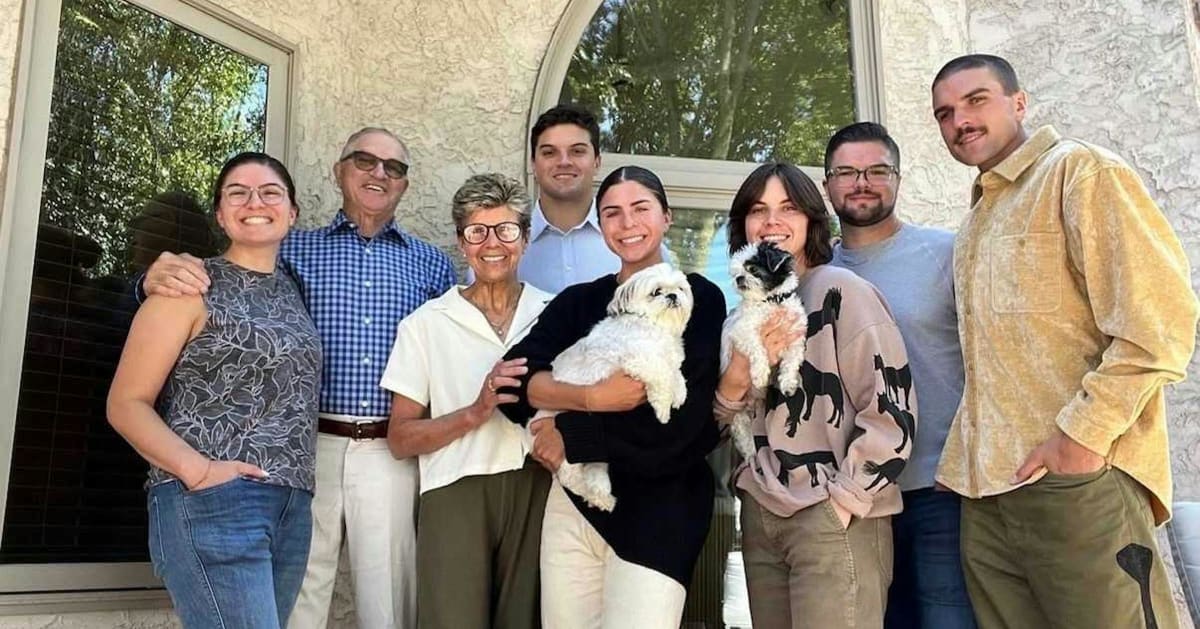 The Klecker family of seven siblings and their parents posing together outdoors