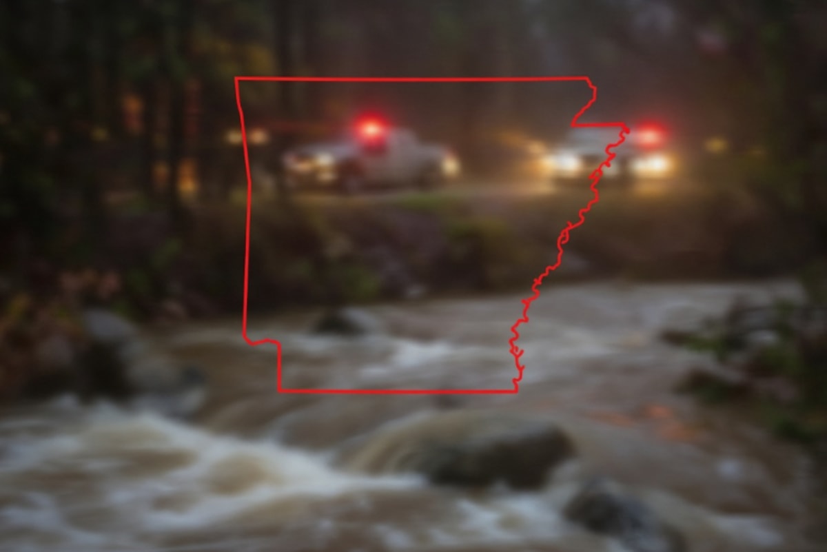 Emergency rescue teams working together to free a vehicle stuck in an Arkansas creek
