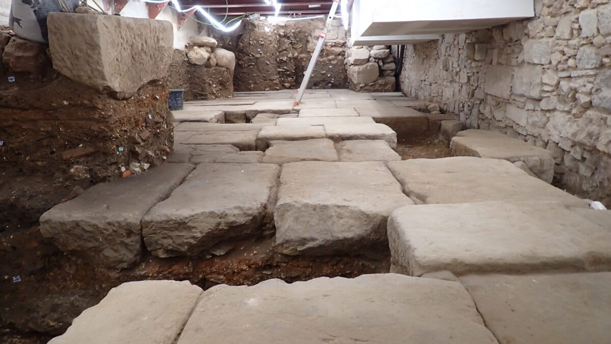 ** Ancient Roman stone pavement with massive rectangular slabs uncovered beneath Barcelona hotel excavation site