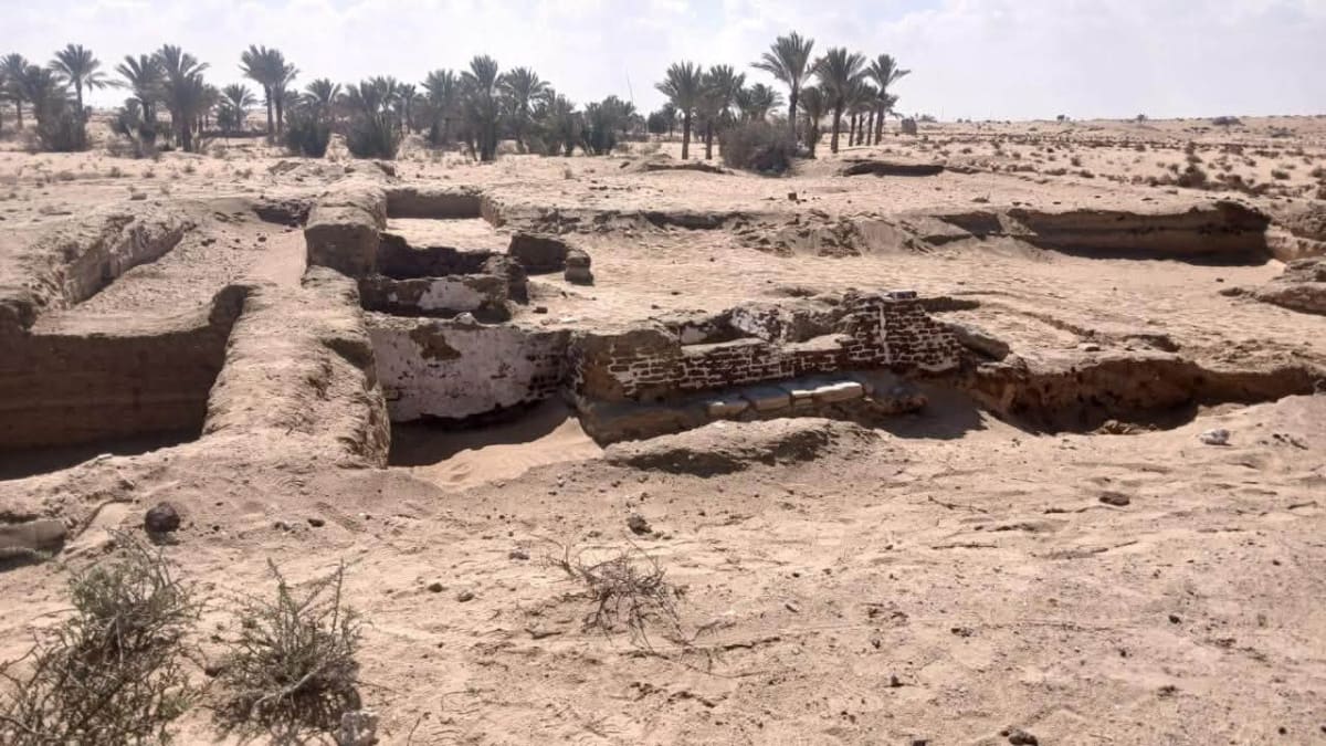 Ancient mudbrick walls and limestone foundation of medieval caravanserai excavation site in Egypt