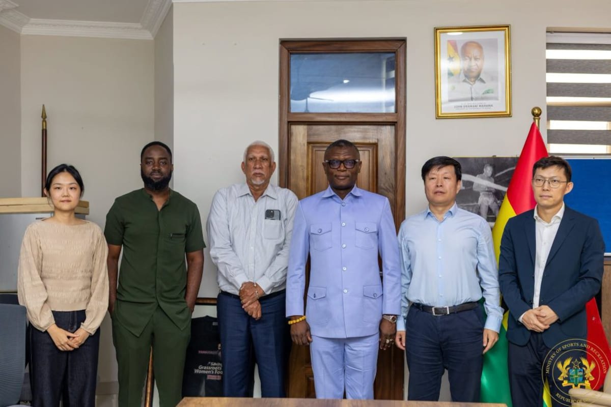 Modern sports stadium with running track representing Ghana's infrastructure development partnership with China