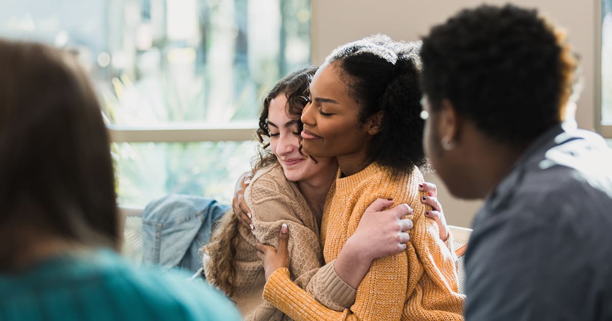Diverse group of young people collaborating together in a community mental health program setting