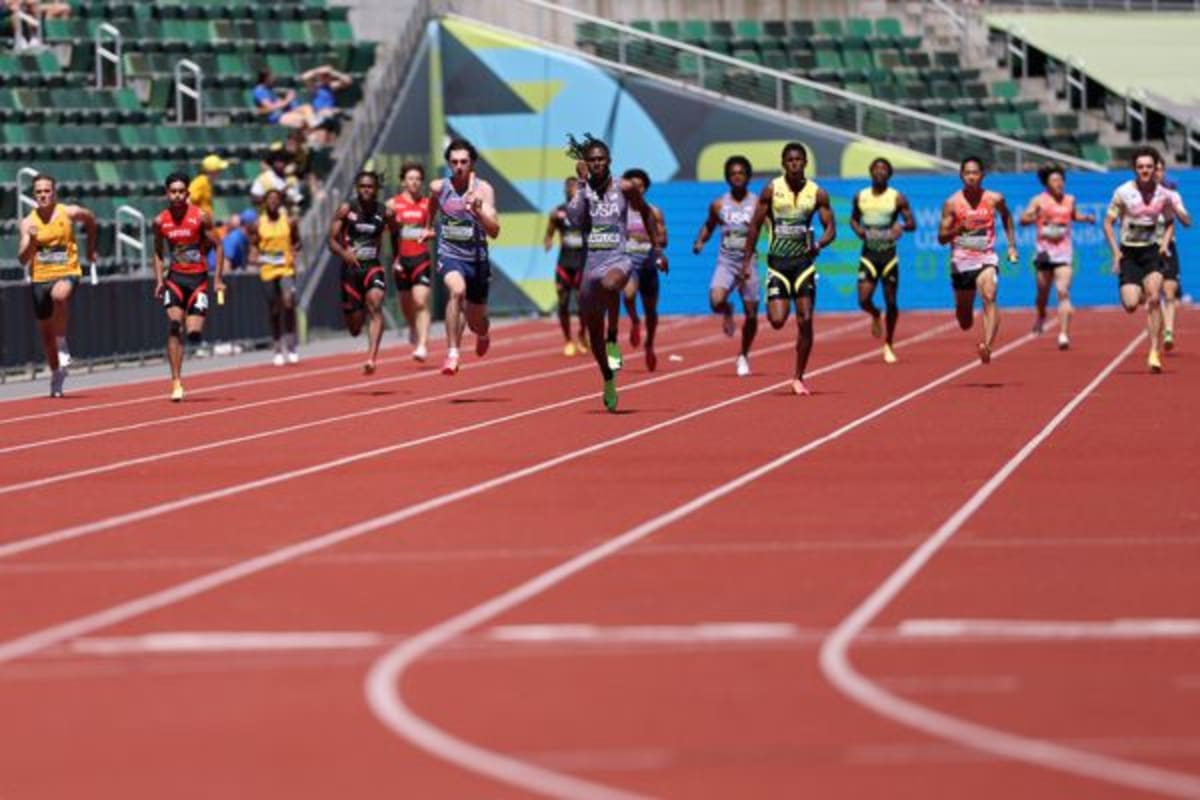Four USA teenage sprinters celebrating together after breaking world U20 4x100m relay record