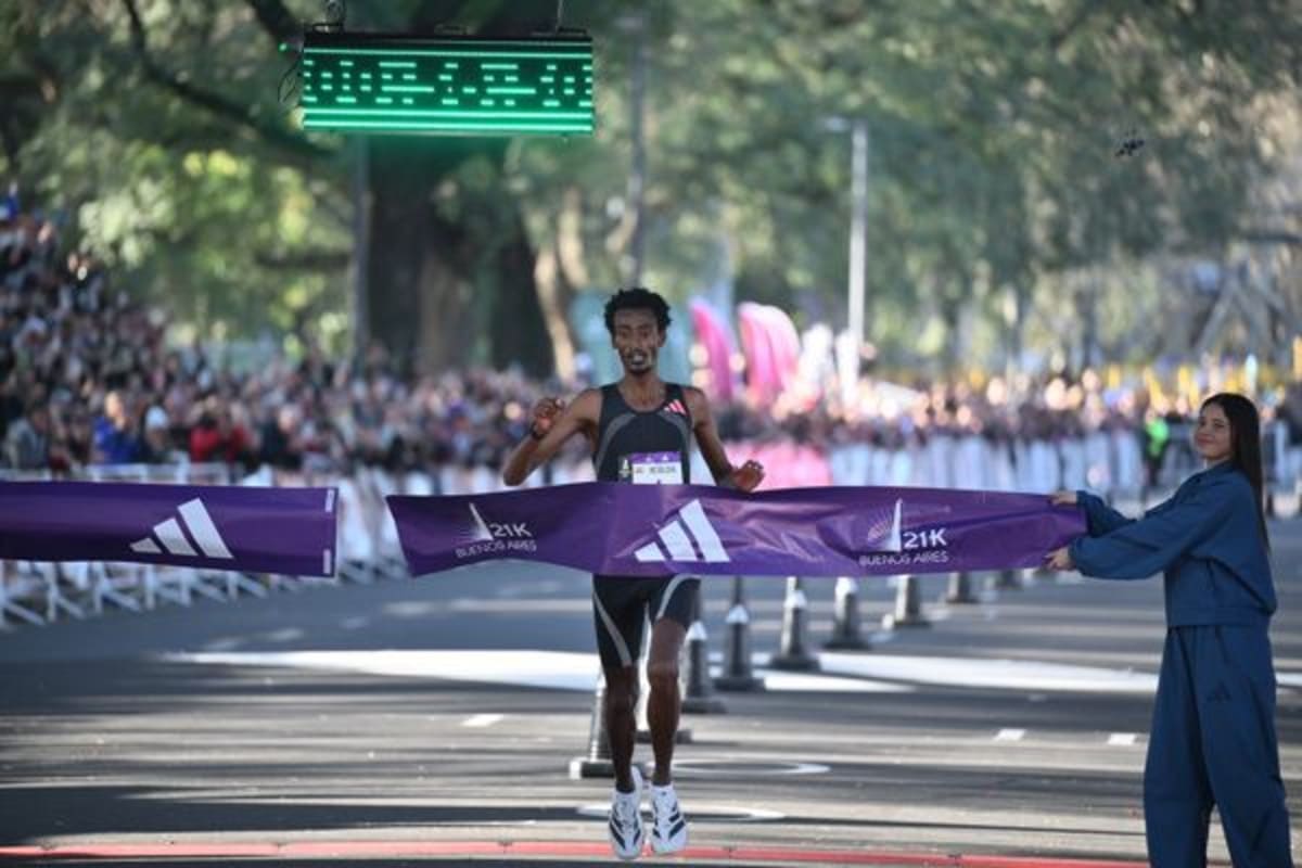 ** Ethiopian runner Yomif Kejelcha crossing finish line at Buenos Aires half marathon world record