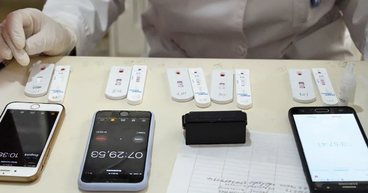 Laboratory researcher examining blood samples for Chagas disease diagnostic testing in clinical setting