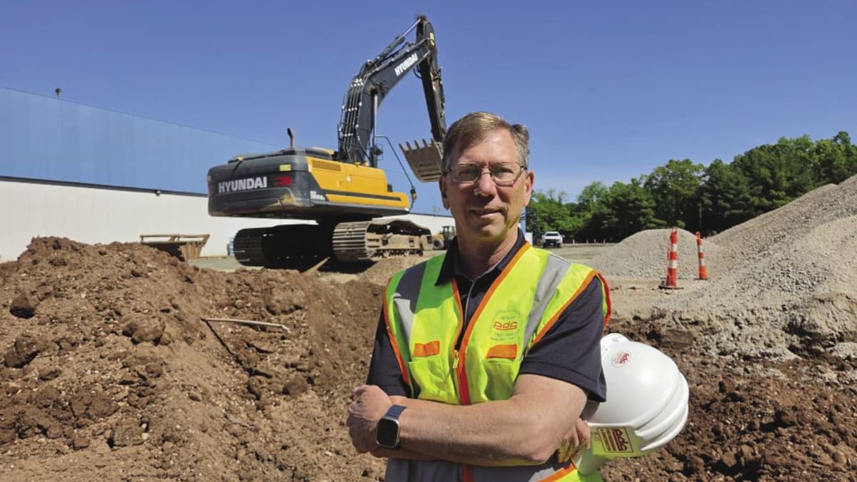 Construction workers building expansion at Connecticut commercial site showing industry employment growth