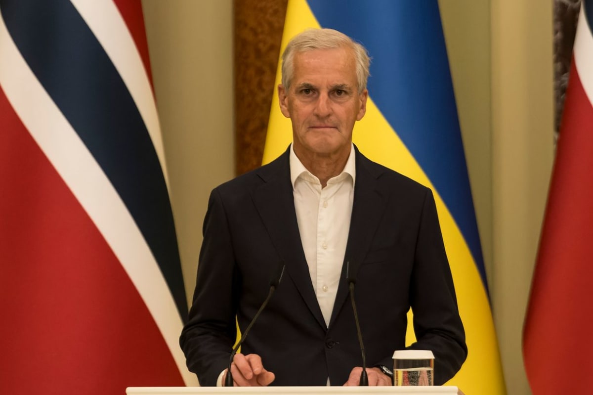 Norwegian and Ukrainian flags side by side with renewable energy solar panels in background