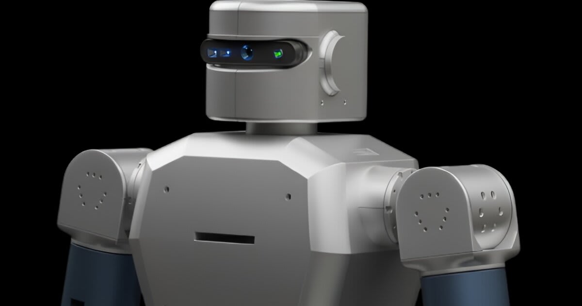 Silver humanoid robot Domo standing in lab setting showing full-body aluminum chassis design