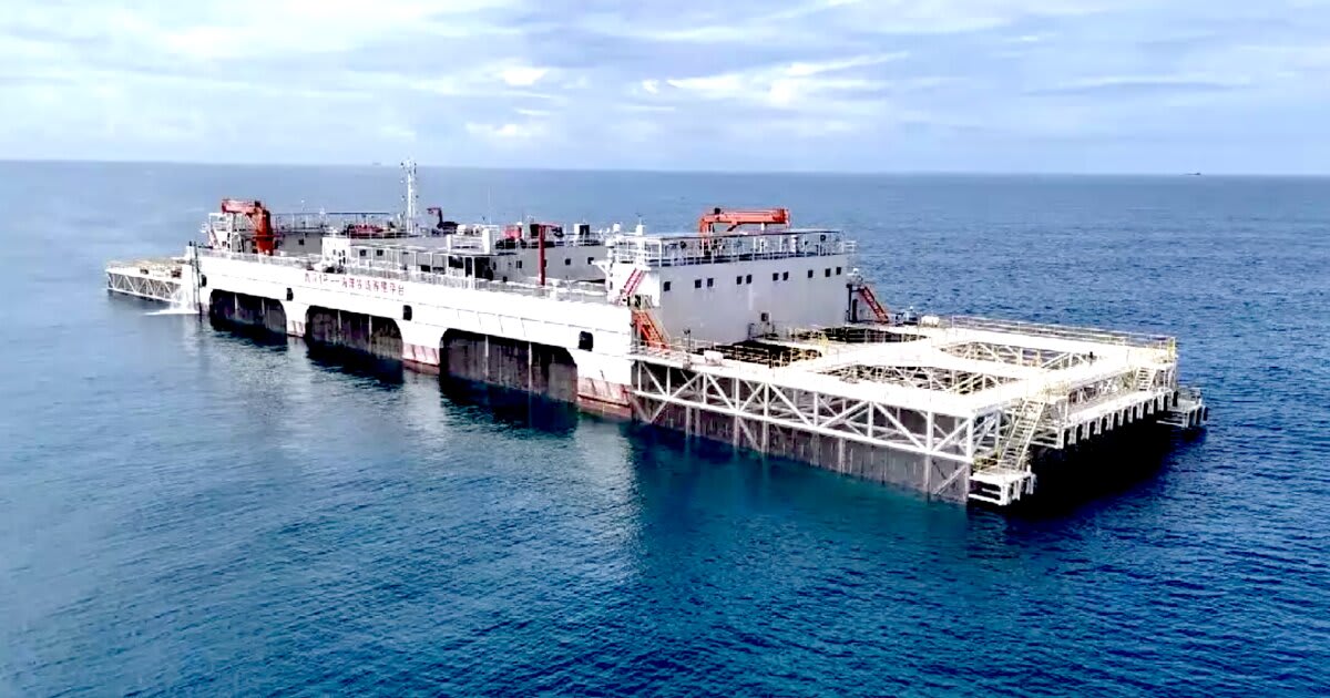 Massive semi-submersible floating fish farm platform Xinhuan No. 1 on blue ocean water