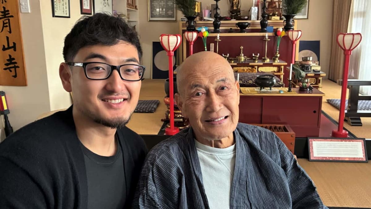 Father and son practice karate moves together on outdoor balcony in Sydney