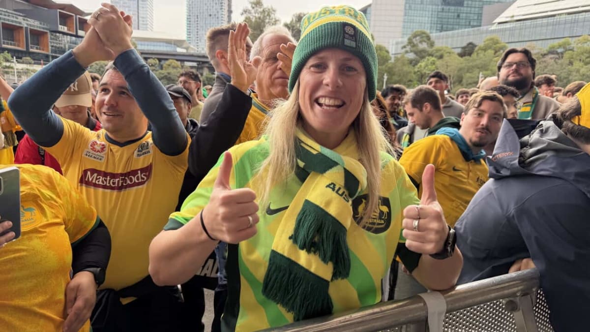 Large crowd of Australian soccer fans in green and gold celebrating at Federation Square Melbourne