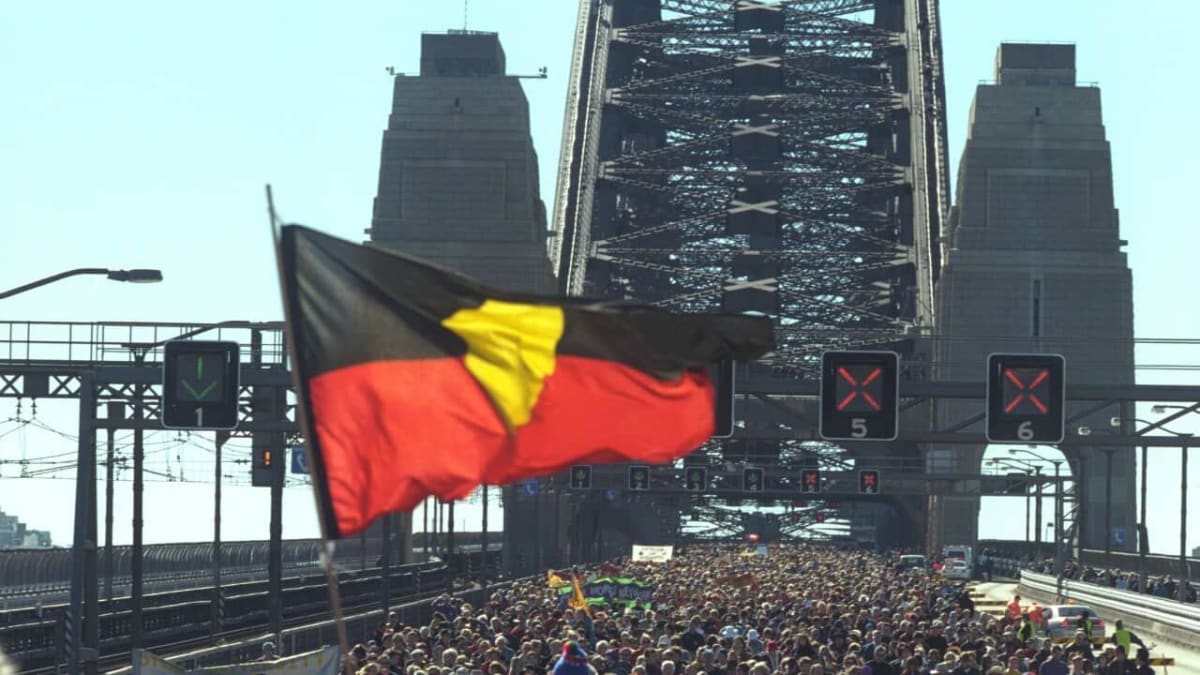 Thousands of people walking together across Sydney Harbour Bridge during the historic 2000 reconciliation walk