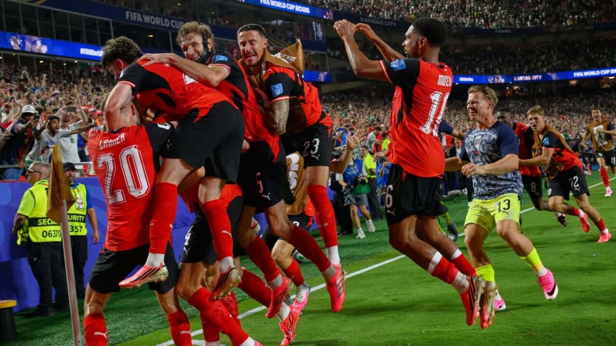 Austrian soccer players celebrating wildly after Kalajdzic's last-second equalizing goal against Algeria