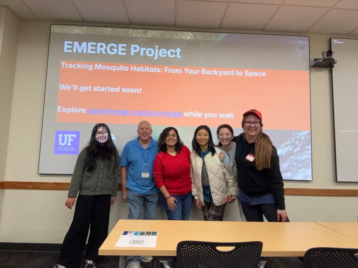 Diverse group of hackathon participants collaborating on laptops at University of Florida library
