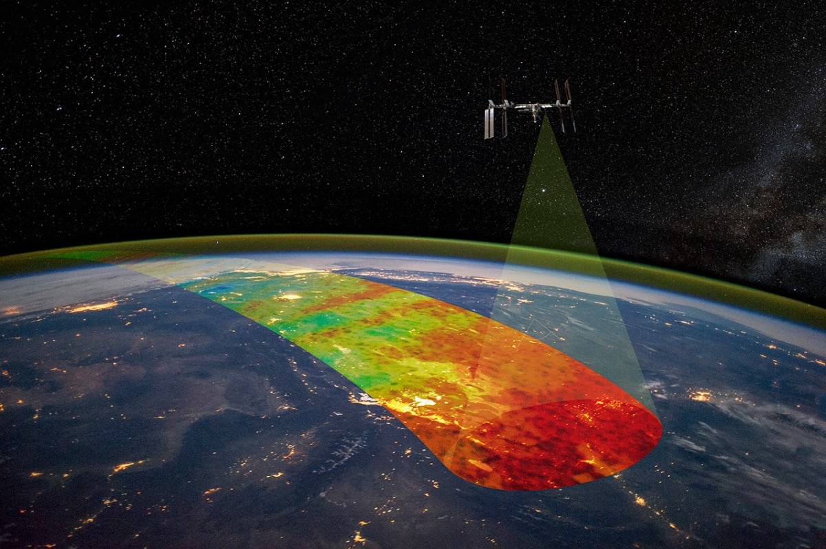 Green and red airglow bands curving around Earth with lightning flash, photographed from space station