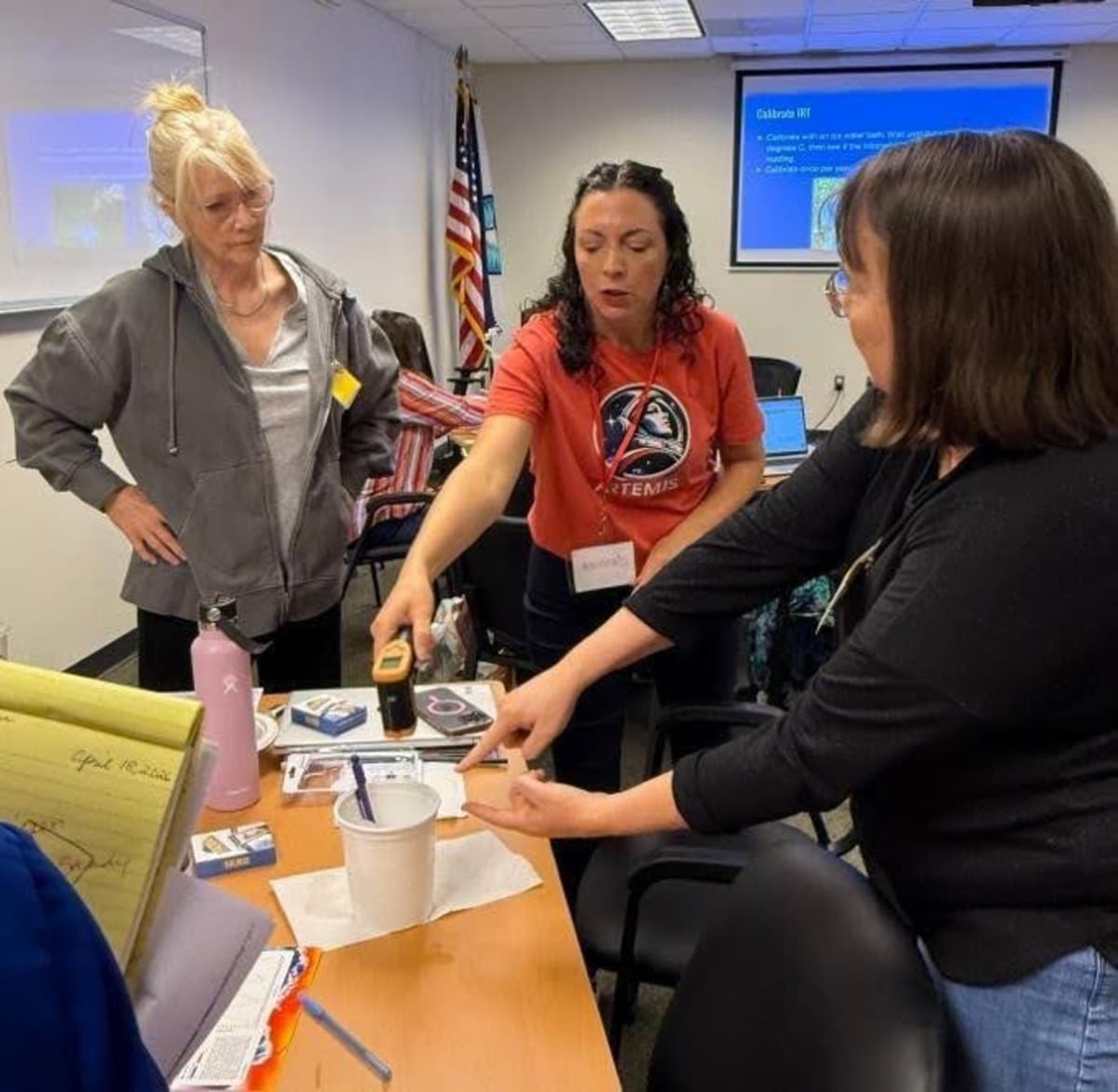 NASA scientist Jessica Taylor demonstrates infrared thermometer calibration to Virginia educators during STEM training workshop